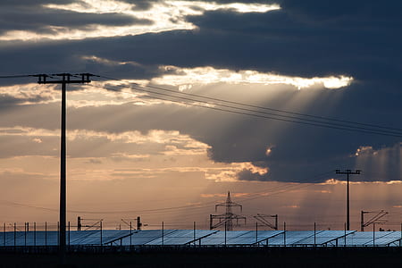silhouette of electric tower and solar panel thumbnail
