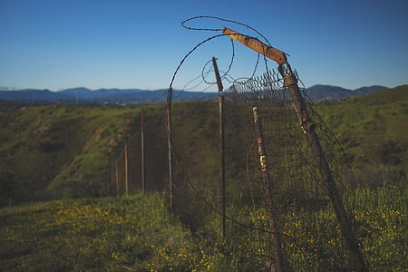 landscape photography of green grass field with fence thumbnail