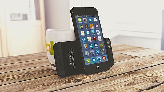 black iPod Touch beside white ceramic mug thumbnail