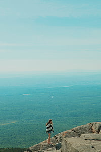 woman standing on top of rock formation thumbnail