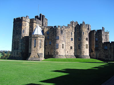 brown castle on green grassland during daytime thumbnail