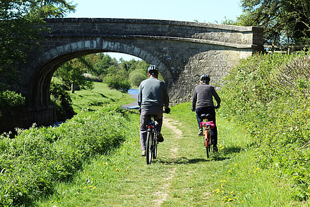 two person riding on bicycles near bridge thumbnail