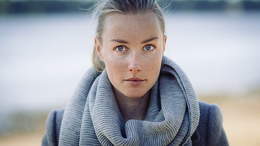 woman wearing gray knitted infinity scarf selective focal photo thumbnail
