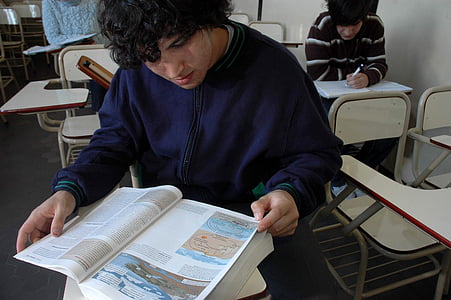 man in blue zip-up jacket reading book thumbnail