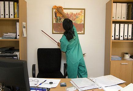 woman cleaning painting inside office thumbnail