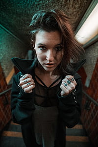 woman in black jacket standing on stairs looking fierce thumbnail