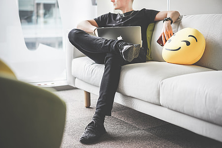Young Man Thinking and Working with Laptop in Office Space thumbnail