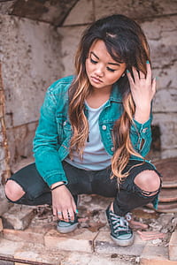 woman squatting on gray surface thumbnail