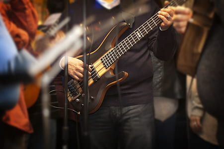 Man Holding Electric Bass Guitar thumbnail