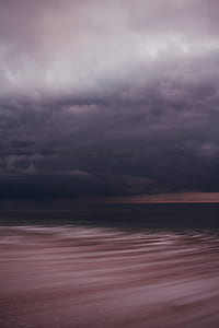 time lapse photo of ocean under stratus clouds thumbnail