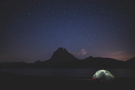 white camped tent near mountains thumbnail