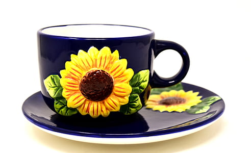 blue and yellow floral ceramic teacup with saucer on white surface thumbnail