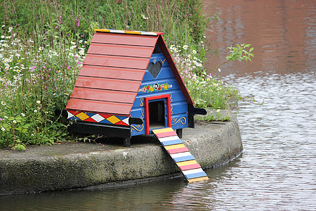 red and blue house beside body of water thumbnail