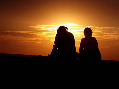 silhouette photo of man two person under golden hou thumbnail
