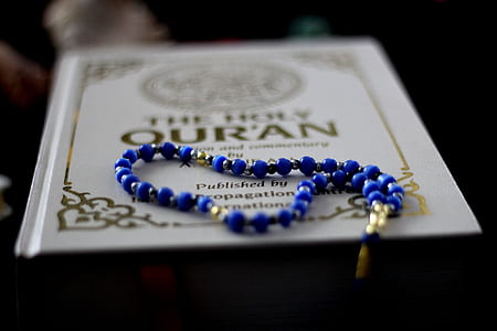 selective focus photography of beaded blue necklace on book thumbnail