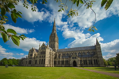 beige building with spire near trees and grass thumbnail