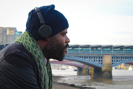 shallow focus photo of man wearing headphones thumbnail