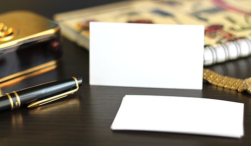 black fountain pen and white paper on wooden table top thumbnail