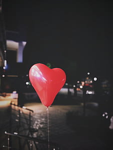 red heart balloon at nighttime thumbnail