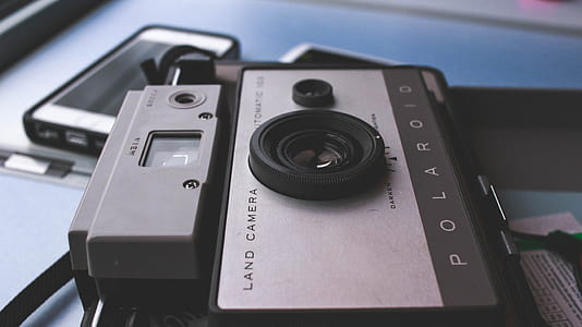 close-up of gray Polaroid land camera on gray surface thumbnail