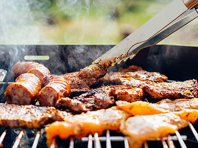 person grilling sausages thumbnail