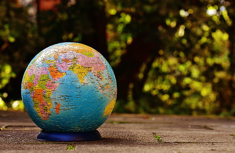 blue and brown desk globe on top of brown surface thumbnail