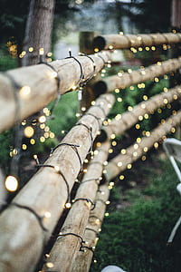 green string lights on brown fence thumbnail