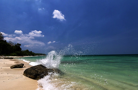 beach water clashed with beach rock during daytime thumbnail