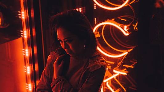 woman in front of orange neon light thumbnail