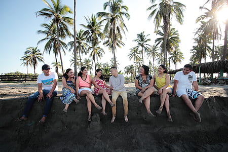 group of people sitting on sand thumbnail