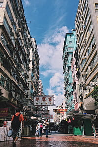 people walking in middle on high rise building thumbnail