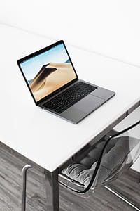 MacBook Pro on White Table at Home thumbnail