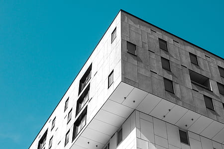white concrete building under blue sky thumbnail