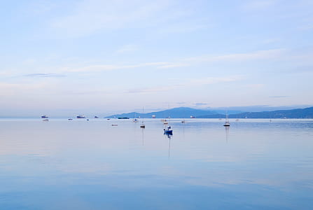 boat on body of water under blue sky thumbnail
