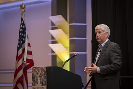 man standing behind podium thumbnail