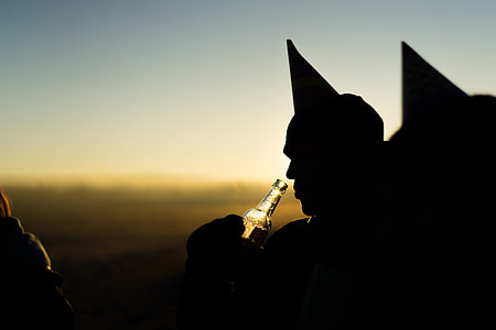 silhouette of a person holding beer thumbnail