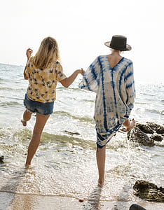 two women on seaside at daytime thumbnail
