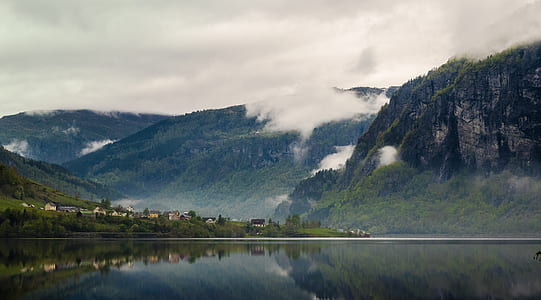 aerial photography of mountain and body of water thumbnail