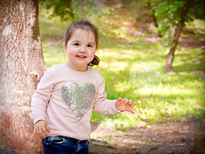 girl standing near tree thumbnail