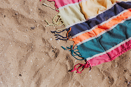 Colorful beach towel on the sand thumbnail