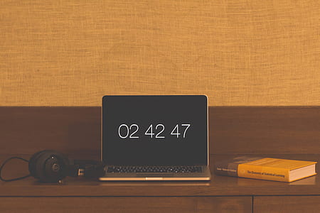 laptop displaying 02 42 47 on top of table thumbnail