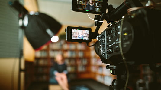 selective focus photo of woman's photo in video camera with lightings thumbnail