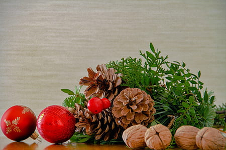 pine cone between baubles and nuts on table thumbnail