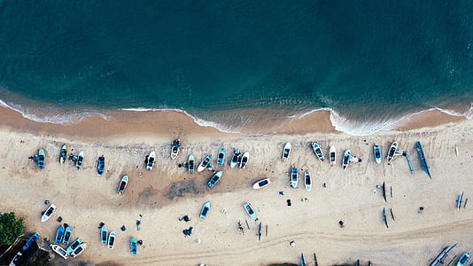 aerial view of beach with boats and peple thumbnail