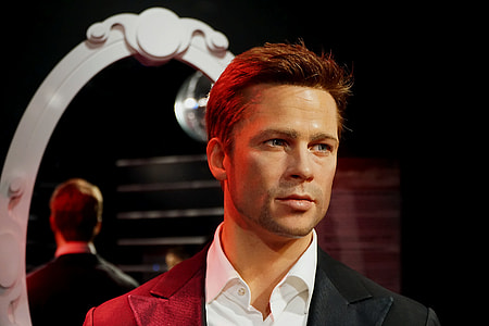 man wearing black peak-lapel blazer standing near white framed mirror thumbnail