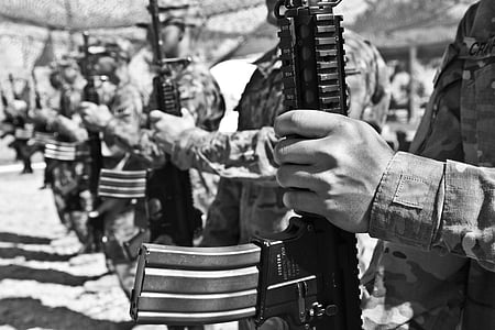 soldiers holding rifles in grayscale photography thumbnail