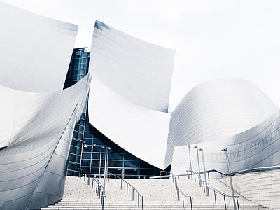 architecture photography of white building under cloudy sky thumbnail