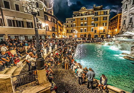 people sitting on stairs near fountain with water painting thumbnail