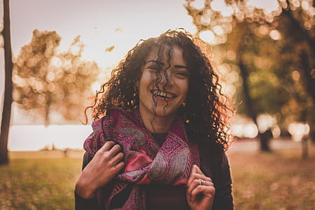 Woman Wearing Pink and Grey Scarf Smiling thumbnail