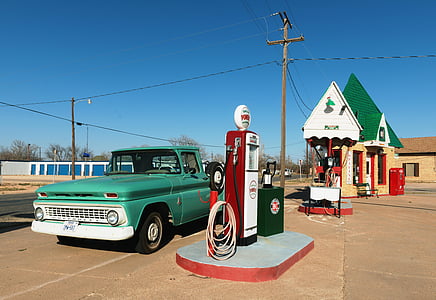teal pickup truck parked at gasoline station thumbnail